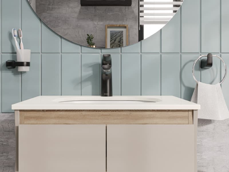 Baño moderno con accesorios negros y espejo redondo